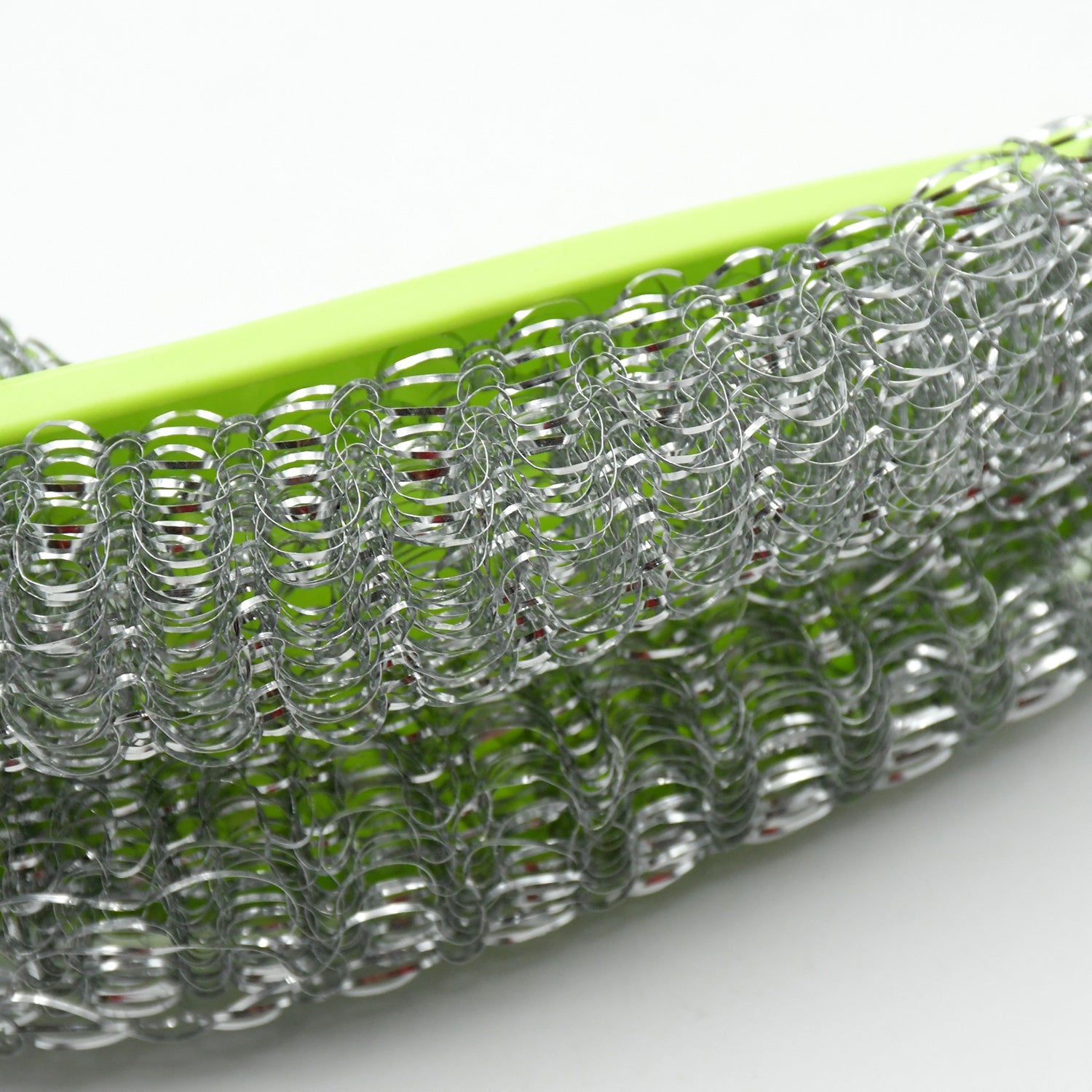 Close-up of kitchen washing brush showing wire bristles and bendable handle.